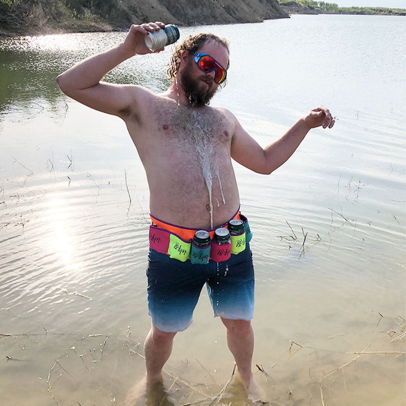  | lake_lifestyle.JPG | Man standing in a lake pouring a beer while wearing The Butt Bar Beer Belt Dayman