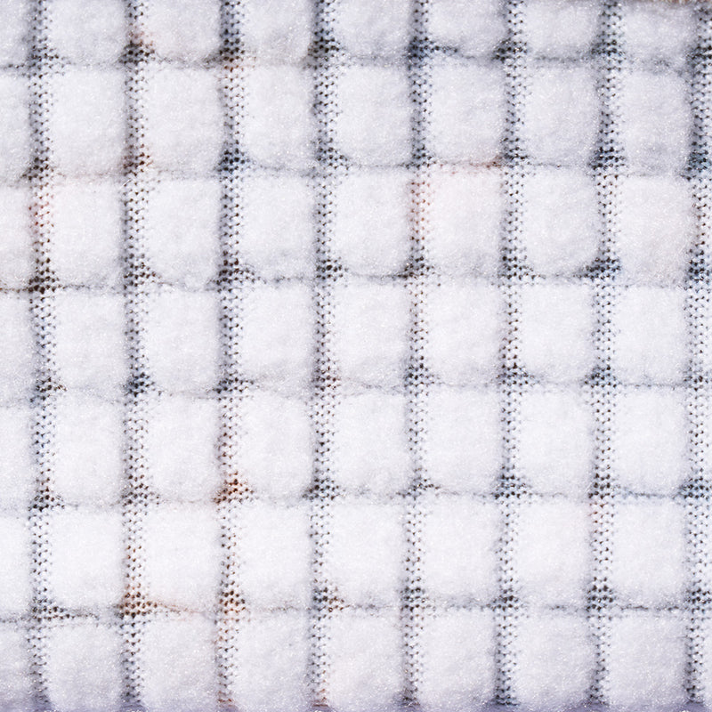 | so_fuzzy_n_warm.JPG | A close-up of a white textured fabric with a subtle gray grid pattern.