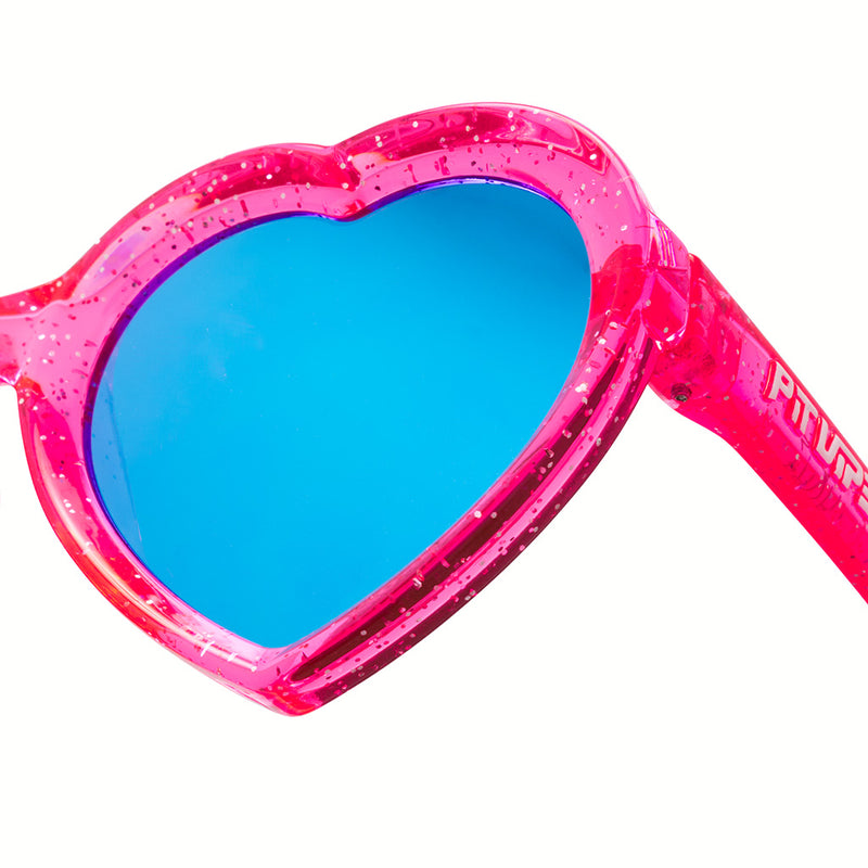 Blue-Purple | im_ready_for_my_closeup.JPG | Heart-shaped sunglasses with a translucent pink glitter frame and bright blue mirrored lenses, shown on a white background.