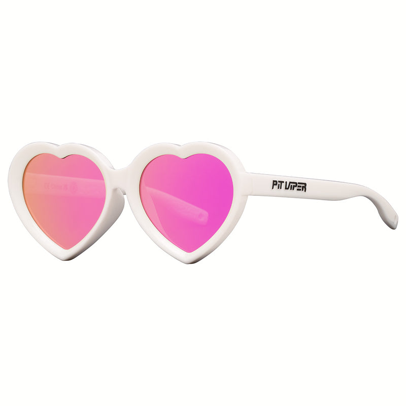 Pink | side_view.JPG | Heart-shaped novelty sunglasses with a thick white frame and vibrant pink mirrored lenses, featuring the brand name 'PIT UPER' printed on the temple arm.