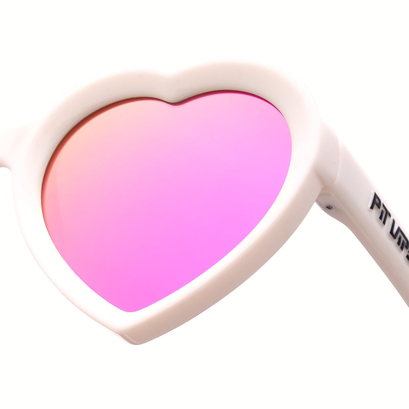 Pink | im_ready_for_my_closeup.JPG | A closeup of a pair of white heart shaped sunglasses with a pit viper logo on the right arm against a white background