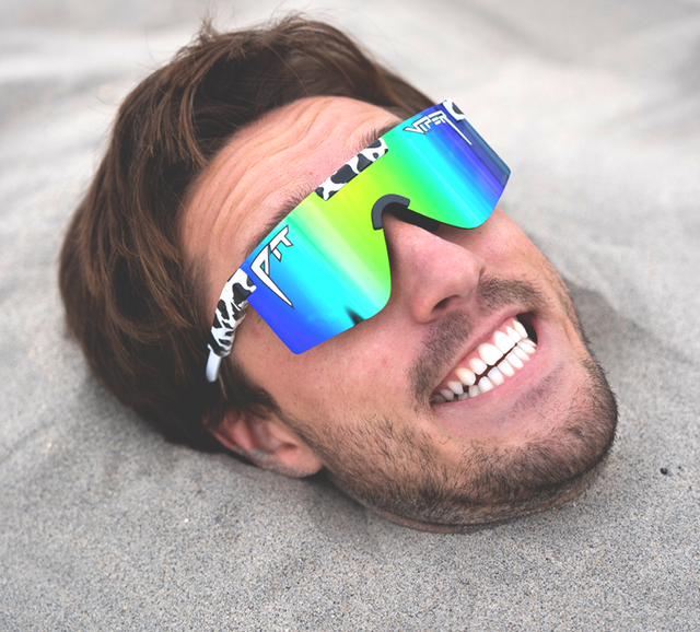 Man cleaning golf balls wearing Pit Viper sunglasses