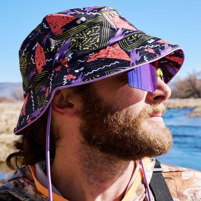 | photo_of_person_2.JPG | Photo of a guy on a river wearing the Sport Beer Bucket hat from Pit Viper.