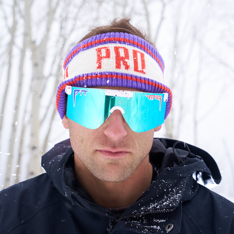 | photo_of_nick_g.JPG | Nick Goepper making a serious face while wearing the Pro Half Hat Headband from Pit Viper in the snowy forest.