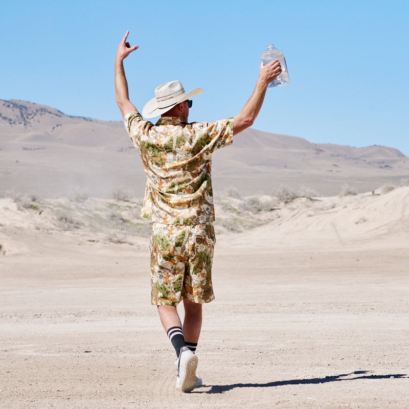  | photo_of_person.JPG | Man in a cowboy hat in the desert wearing the actualbush sport denim shorts from Pit Viper