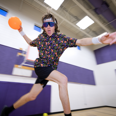 Photo of man playing dodgeball in a gym wearing the sport beer tear away button down shirt from pit viper.