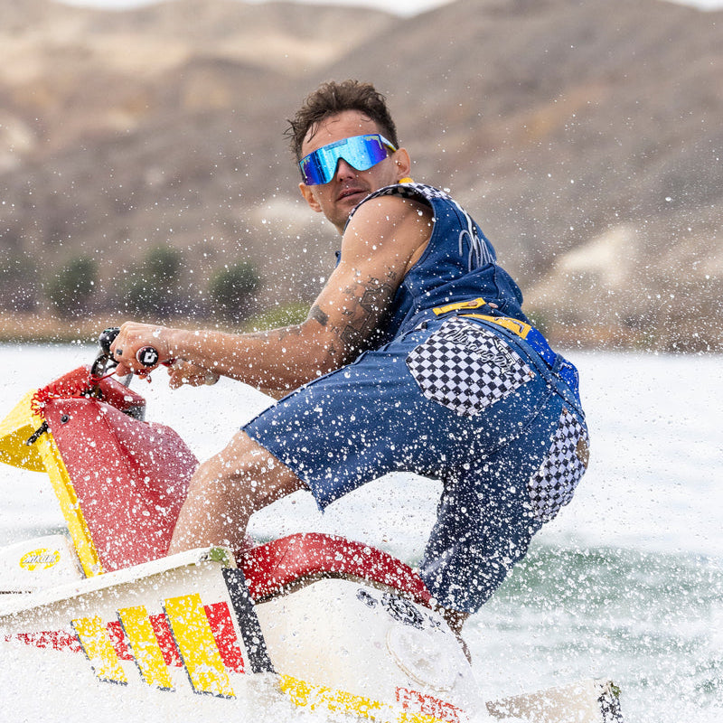 Person water skiing on a lake with mountains in the background
