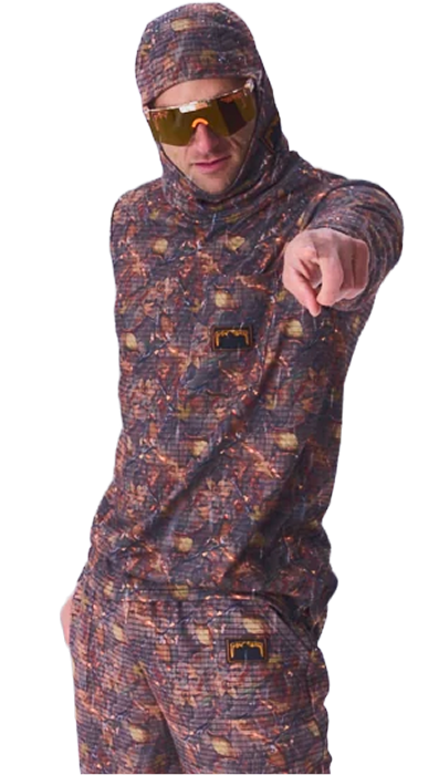 A man wearing a full-body camouflage tracksuit with a hooded jacket, matching pants, and reflective gold-tinted sunglasses, pointing forward against a plain white background.