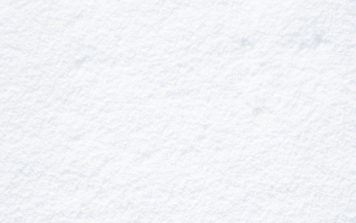 A close-up texture of white snow with fine, soft granules and subtle shadows.
